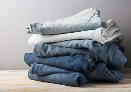 stack of blue jeans on light backgroundの写真素材