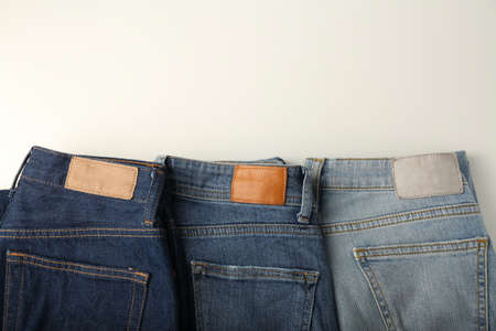 Blue jeans of different shades on a white background, top viewの写真素材