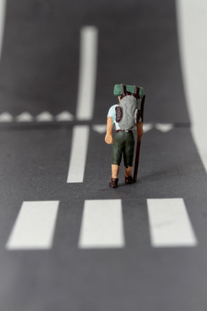 Miniature people : Traveler standing on the road with crosswalkの写真素材