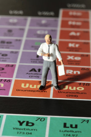 Businessman standing on the periodic table of chemical elementsの写真素材