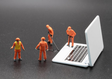 Miniature people worker repairing laptop on black background, Work from home conceptの写真素材