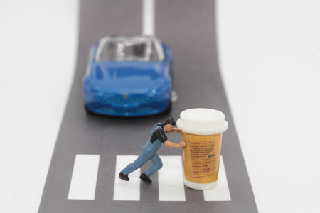Miniature people : delivery man walking on the road with a cup of coffee