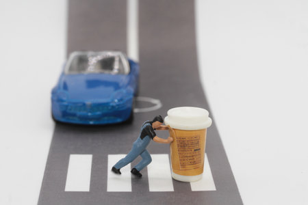 the Miniature people : Businessman standing on the road with car and delivery man pushing a giant cup of coffeeの写真素材