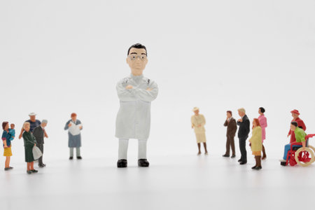 Miniature people : Doctor standing on white background, medical concept.の写真素材