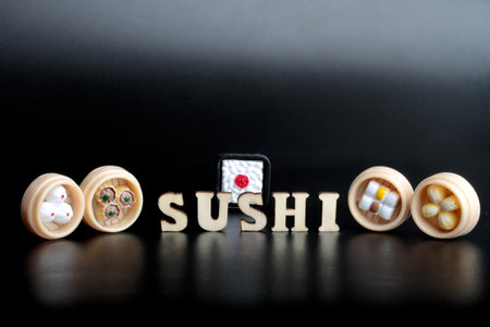 The word SUSHI is made up of wooden letters and dice on a black backgroundの写真素材