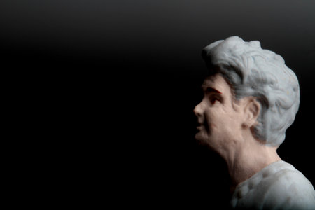 Statue of an old woman on a black background. studio shot.の写真素材