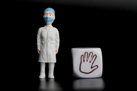 Miniature female doctor and open hand symbol on a black background.の写真素材