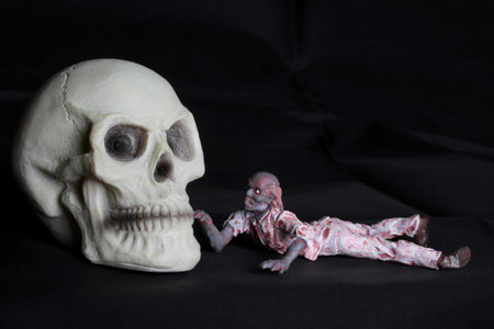 Still life with human skull and mummy on black background, Halloween concept