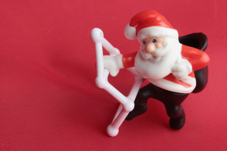 Santa Claus figures on red background. Christmas and New Year concept.の写真素材