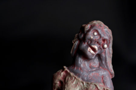 Zombie statue on black background. Halloween concept. Selective focus.の写真素材