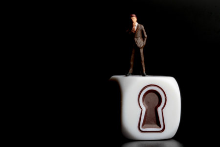 Miniature people: Businessman standing on a white cube with keyhole.の写真素材