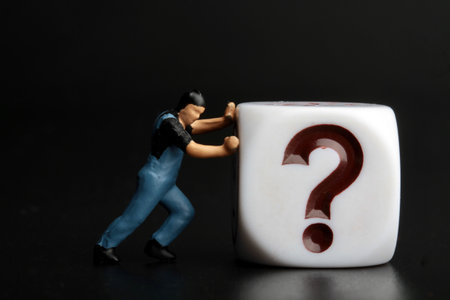 Repairman repairing a question mark with black backgroundの写真素材