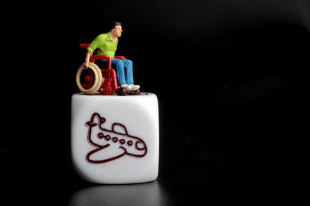 Miniature people : Wheelchair on white block with black background