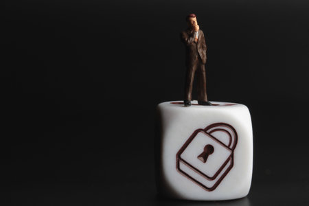 Miniature people : Businessman standing on a white cube with lock padlockの写真素材