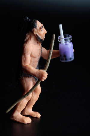 Figurine of a man with a straw and a candle on a black backgroundの写真素材