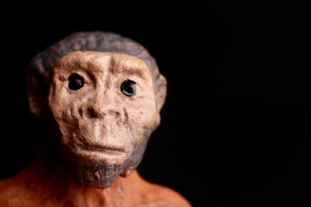 Wooden statue of a monkey on a black background close-upの写真素材