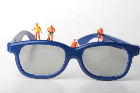 Miniature people : Worker in Safety Glasses on white background.の写真素材