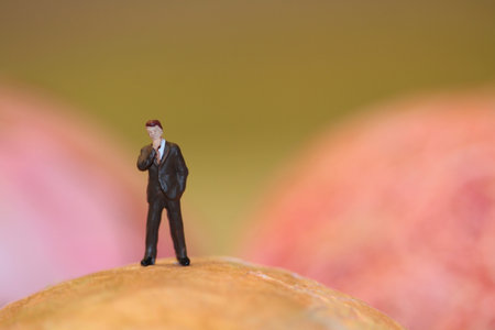Miniature people : Businessman standing on the edge of a sphereの写真素材
