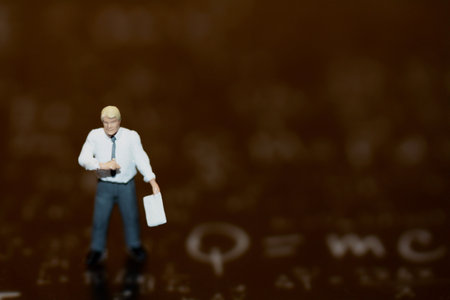 Miniature people : Businessman standing on black background. Image use for business concept.の写真素材
