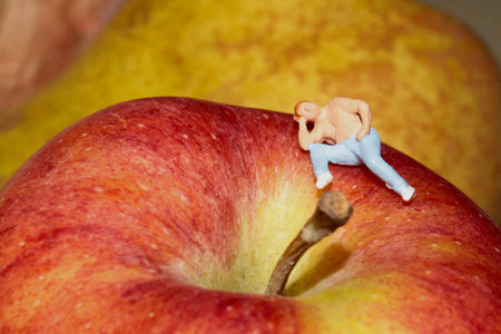 Miniature people: man and big red apple. Healthy food concept.の写真素材