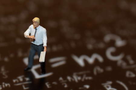 Miniature people: Businessman standing on the background of mathematical formulas.の写真素材