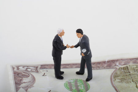 Businessman and businessman shaking hands with money background, business concept.の写真素材
