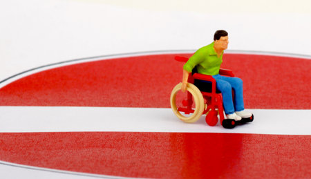 Miniature people : Wheelchair handicapped man in wheelchair on dart boardの写真素材