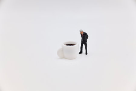 miniature people with coffee cup on white background, business concept.の写真素材