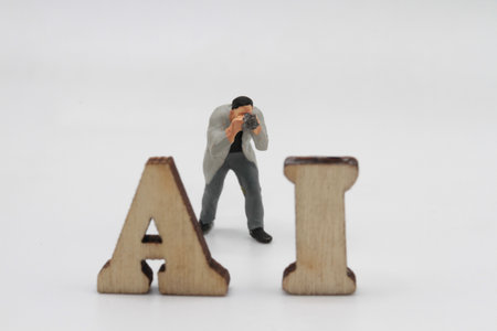 Miniature figurine of a photographer taking pictures of artificial intelligenceの写真素材