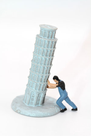 Miniature people: man standing near the Tower of Pisaの写真素材