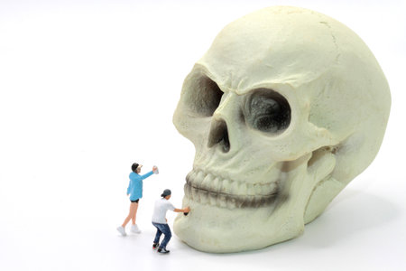 Miniature people : Couple with skull on white background.の写真素材