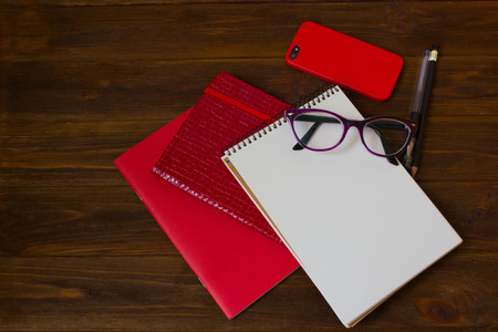 Business concept with notebook, mobile phone, eye glasses and pensの写真素材