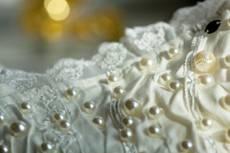 textile wedding background with beads. Tiny pearls embroidered over a wedding dressの写真素材
