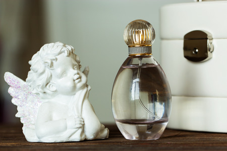 dressing table with women's accessories. perfume, jewelry and makeup brushes on a  table, close-upの写真素材