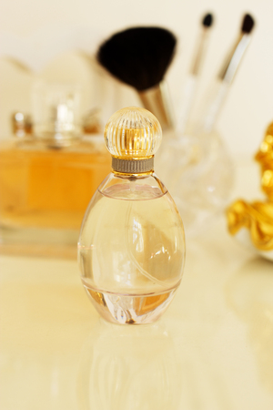 dressing table with women's accessories. perfume, jewelry and makeup brushes on a  table, close-upの写真素材