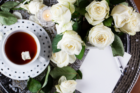 Wedding background . Valentine's day background . Cup of coffee and a lot of rosesの写真素材
