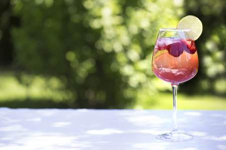 Homemade Summer Berry Drink. Lemonade with  strawberry with lime, mint in glass on table の写真素材
