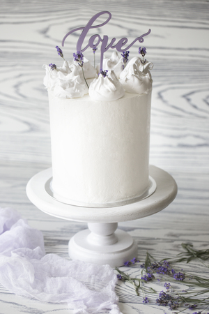 Delicious white wedding cake decorated with word "love". White Wedding Cake With Love Wordの写真素材