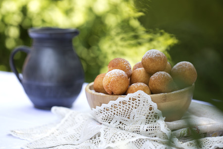 Small balls of freshly baked homemade cottage cheese doughnuts in a plate . Donuts In powdered sugar.の写真素材