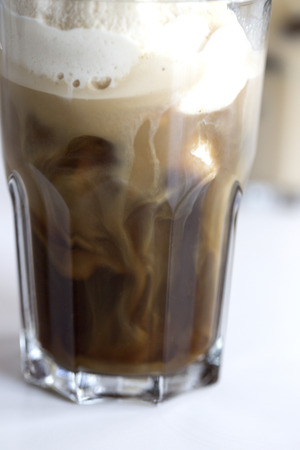 coffee ice in glass. Iced coffee cocktail or frappe with ice cubes and cream