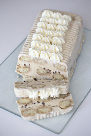 delicious ice cream cake. Tiramisu with italian savoiardi cookies, mascarpone, milk chocolate, with...