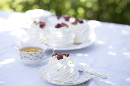 Pavlova cakes with cream and fresh summer berriesの写真素材