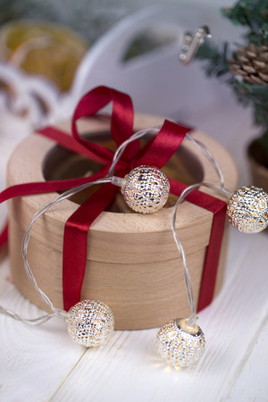 Christmas holidays composition with copy space for your text. Christmas gift box in craft paper with red ribbon. round gift box with red ribbonの写真素材