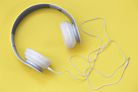 white headphones on yellow background. Music concept. Earphones on yellow background.の写真素材