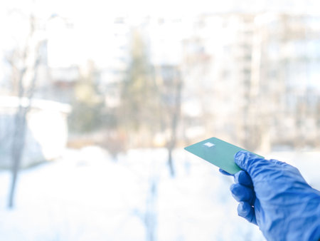 Holding the credit card in his hand, he pulled it out of his wallet. For business, shopping, and finance, the hand takes a payment card from a wallet with space for text.の写真素材