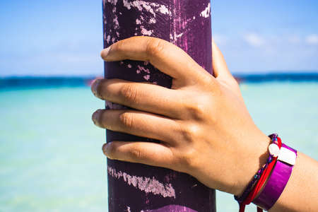 hand of a woman on vacation relaxing and happy under the sun in the paradise of the caribbean sea in early spring and late summer.の写真素材