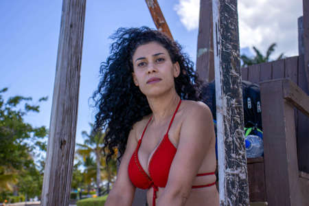 Young sexy female lifeguard in red bikini hanging over the Caribbean Sea to prevent any drowning of bathers. baywatch.の写真素材