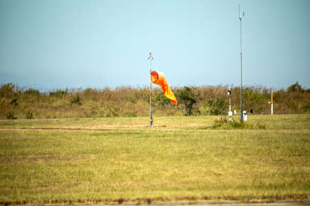 Wind direction flag of an airport, this is the flag that indicates the direction of the wind to be taken into account in airplanes, this flag is located in the rainbow nation which is South Africa.の写真素材