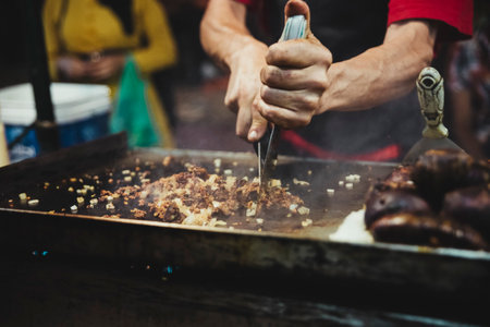 Cook cutting the meat of street food in the square of Beni Mellal which is a city in Morocco, capital of the homonymous province and the region of Beni Mellal-Khenifra. Street food concept.の写真素材