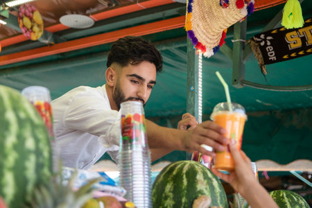 Marrakech, Morocco - October 17, 2022: Merchant selling a juice shake that is made with fresh fruit in the Jemaa el Fna square in Marrakech, this square is the main one in this city in Morocco.のeditorial素材